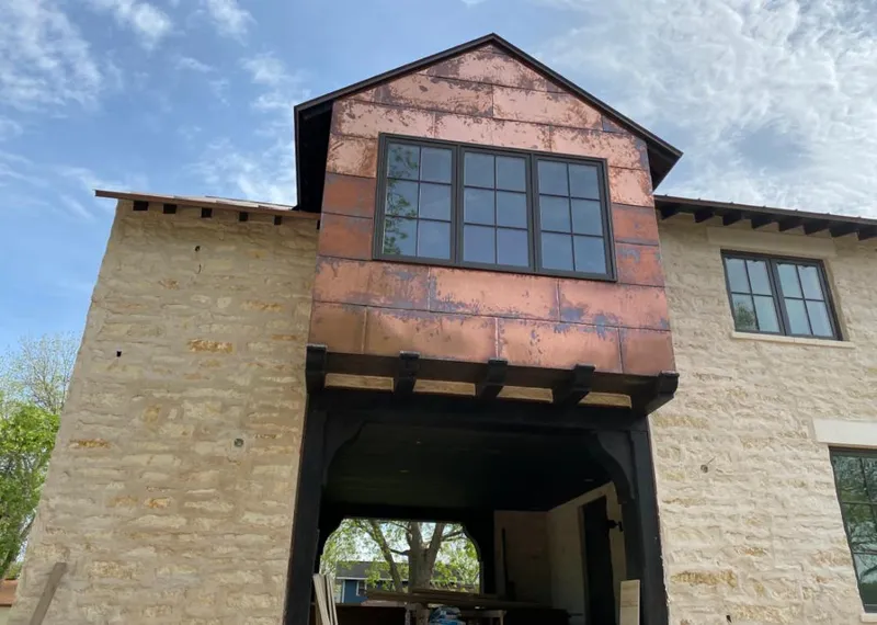 Copper metal panel facade on a stone building for Skylight Installation in Gleneagle