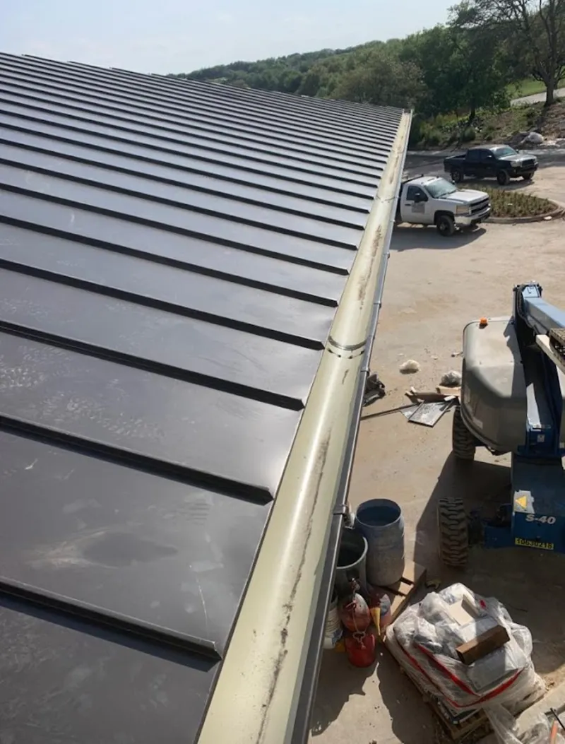 Standing seam panel and gutter detail on a metal roofing jobsite in Gleneagle